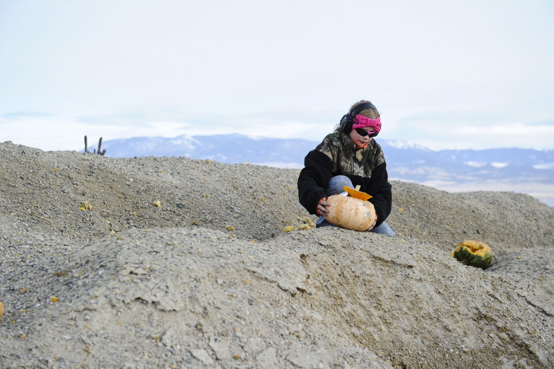 Tobey Peck, 11, places her Tannerite filled pumpkin down range Saturday.